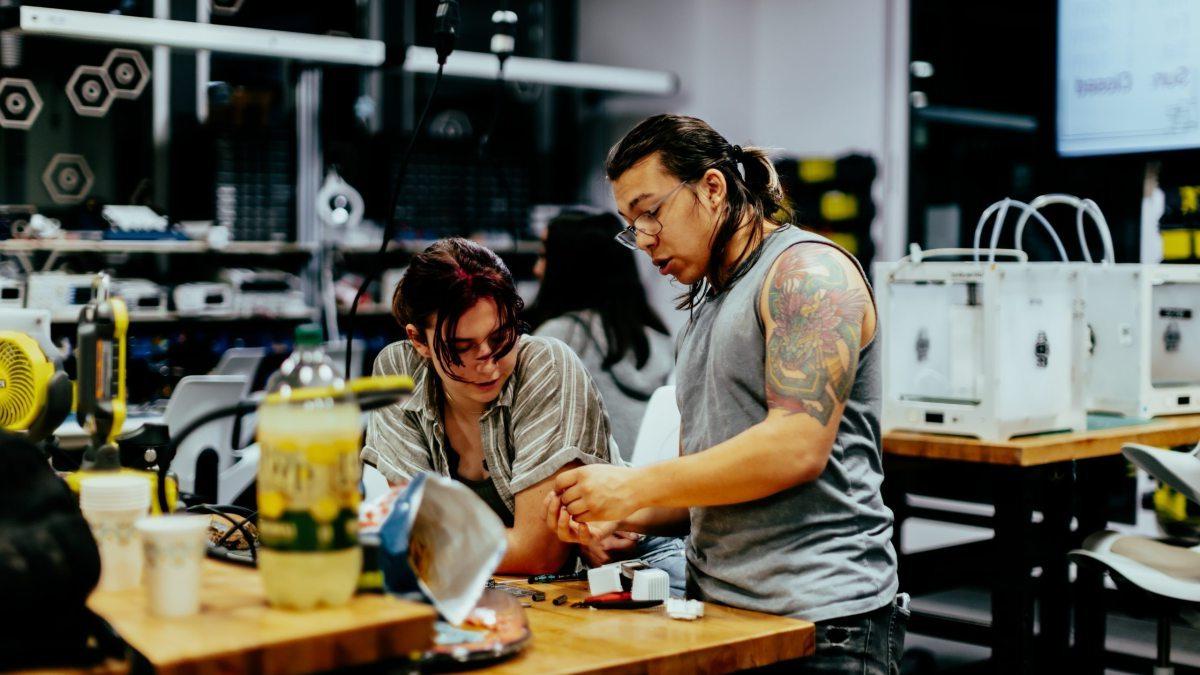 Two students working together at a table.